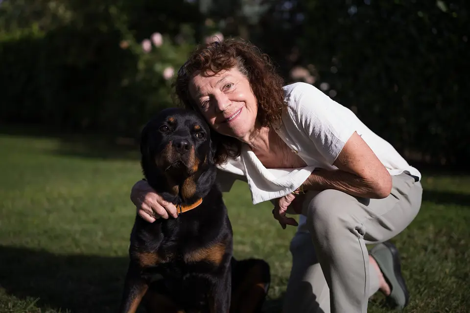 Hanne Petzold schmiegt sich an den Rottweiler – Gastgeberin und Hund im Garten des Weinberghauses